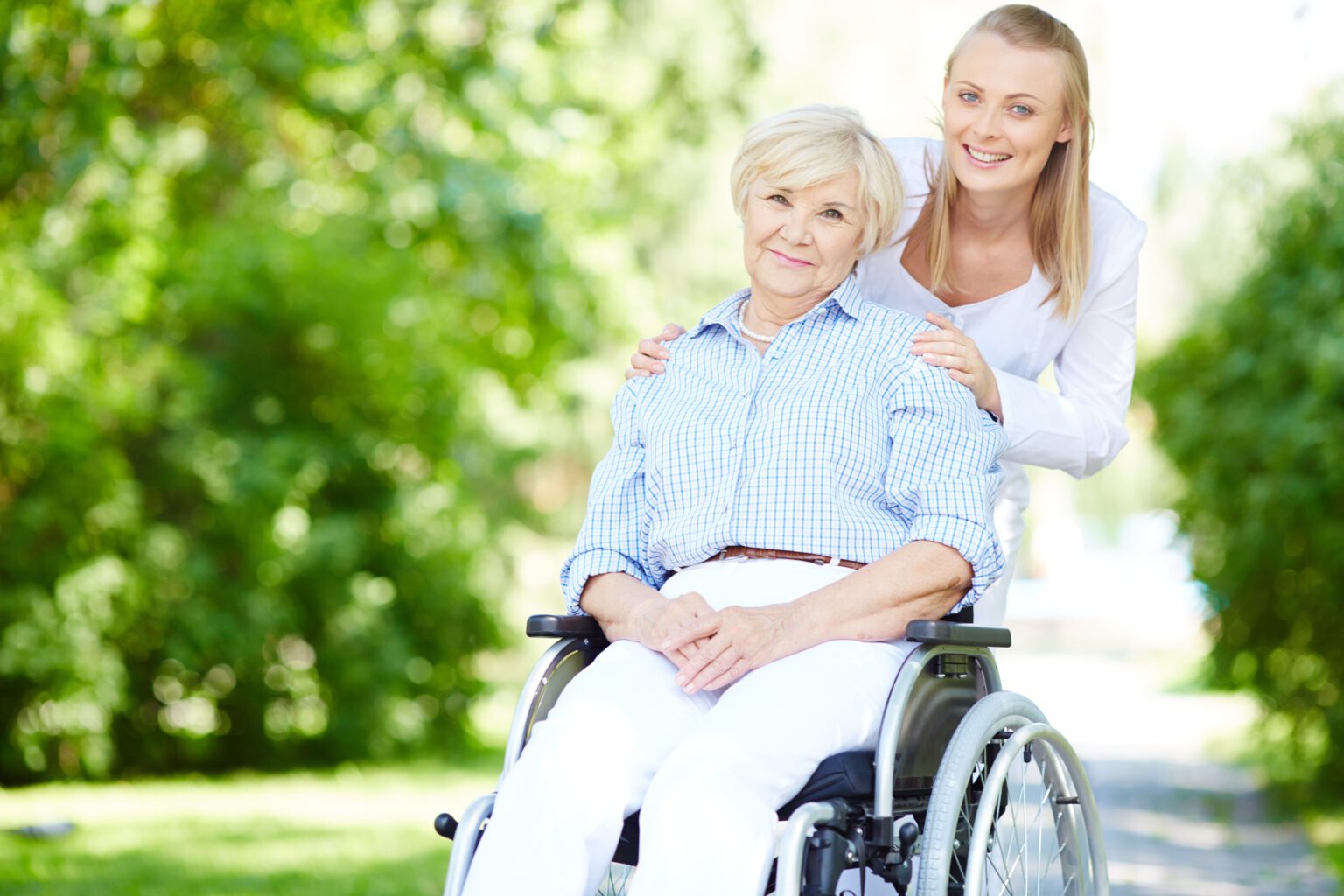 Caregiver with senior in wheelchair